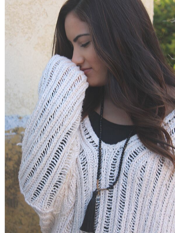 long black necklace on model with chunky sweater